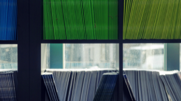 Color coded file folders on shelves